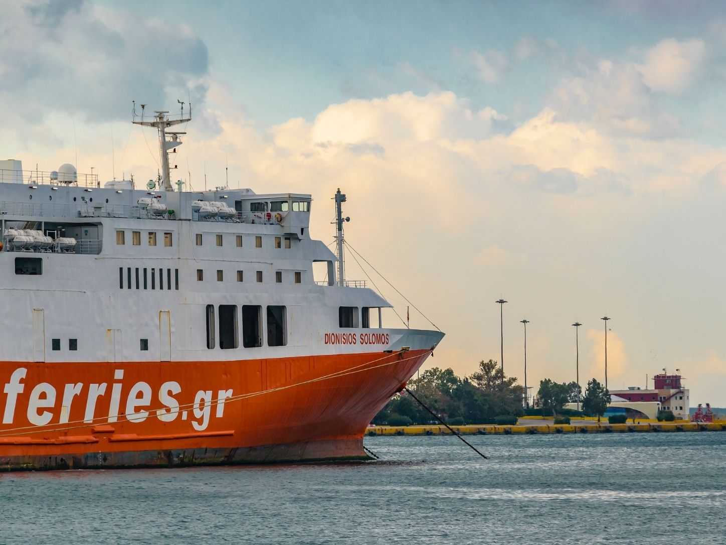 A Greek ferry berthed alongside the quay under a soft evening sky