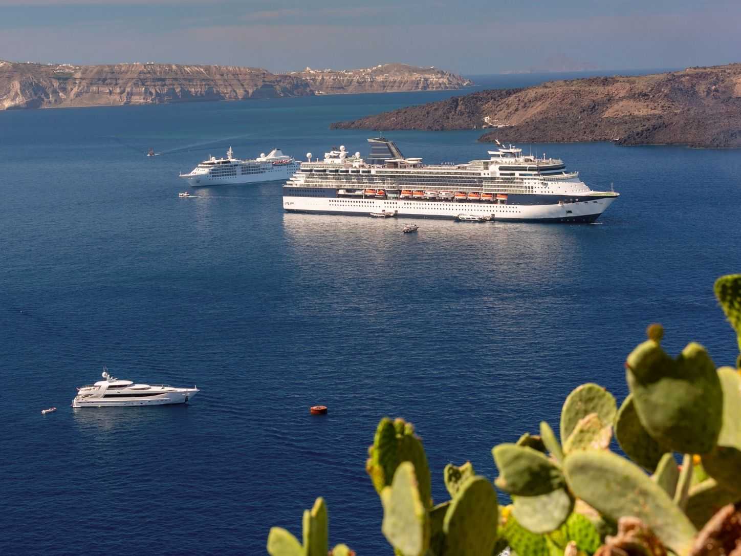 Cruise ships anchored in the Santorini caldera below the cliffs of Thira
